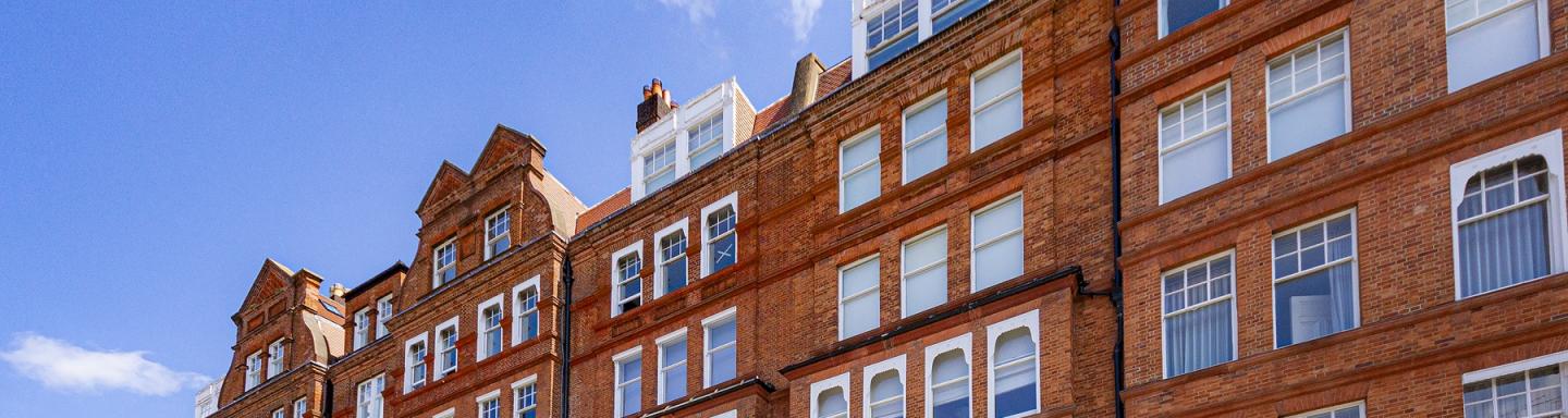 A large red brick apartment block in Kensington, London