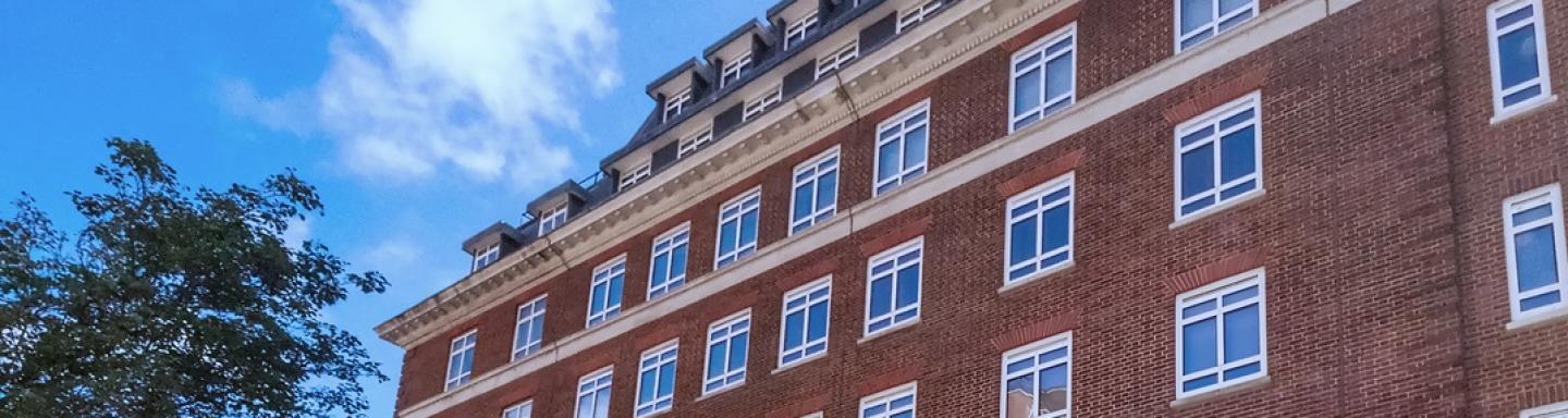 Part of the red brick facade of a residential apartment block in Westminster