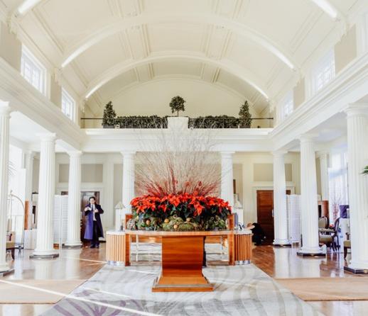 Communal lobby of an exclusive London apartment block with large central table and flower display