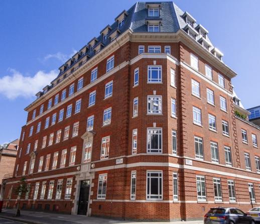 A large red brick apartment building in London