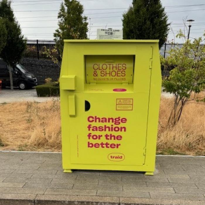 A bright yellow clothes bank installed on a residential development in East London