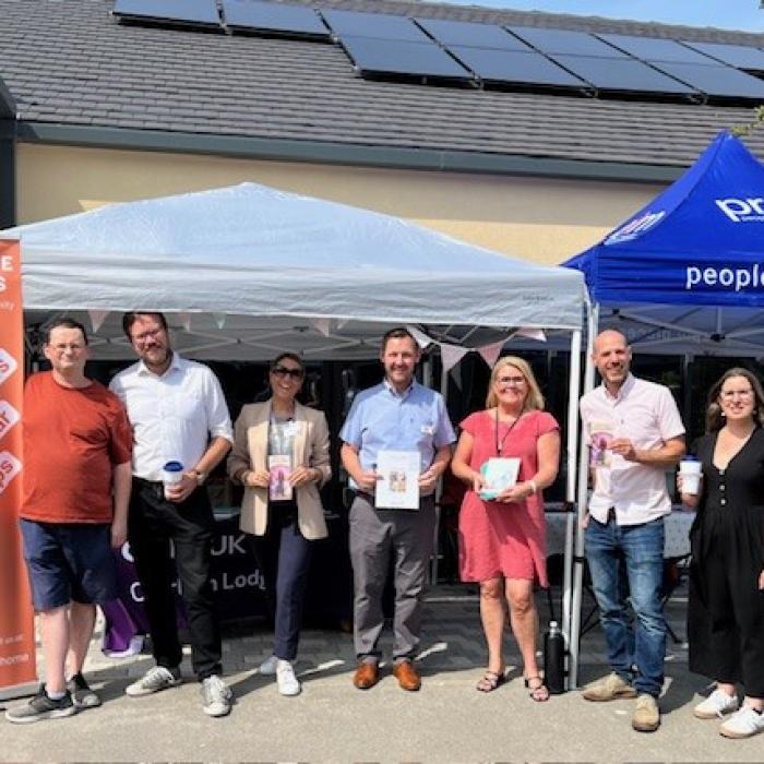 A group of people attending a community drop in session at a UK residential development